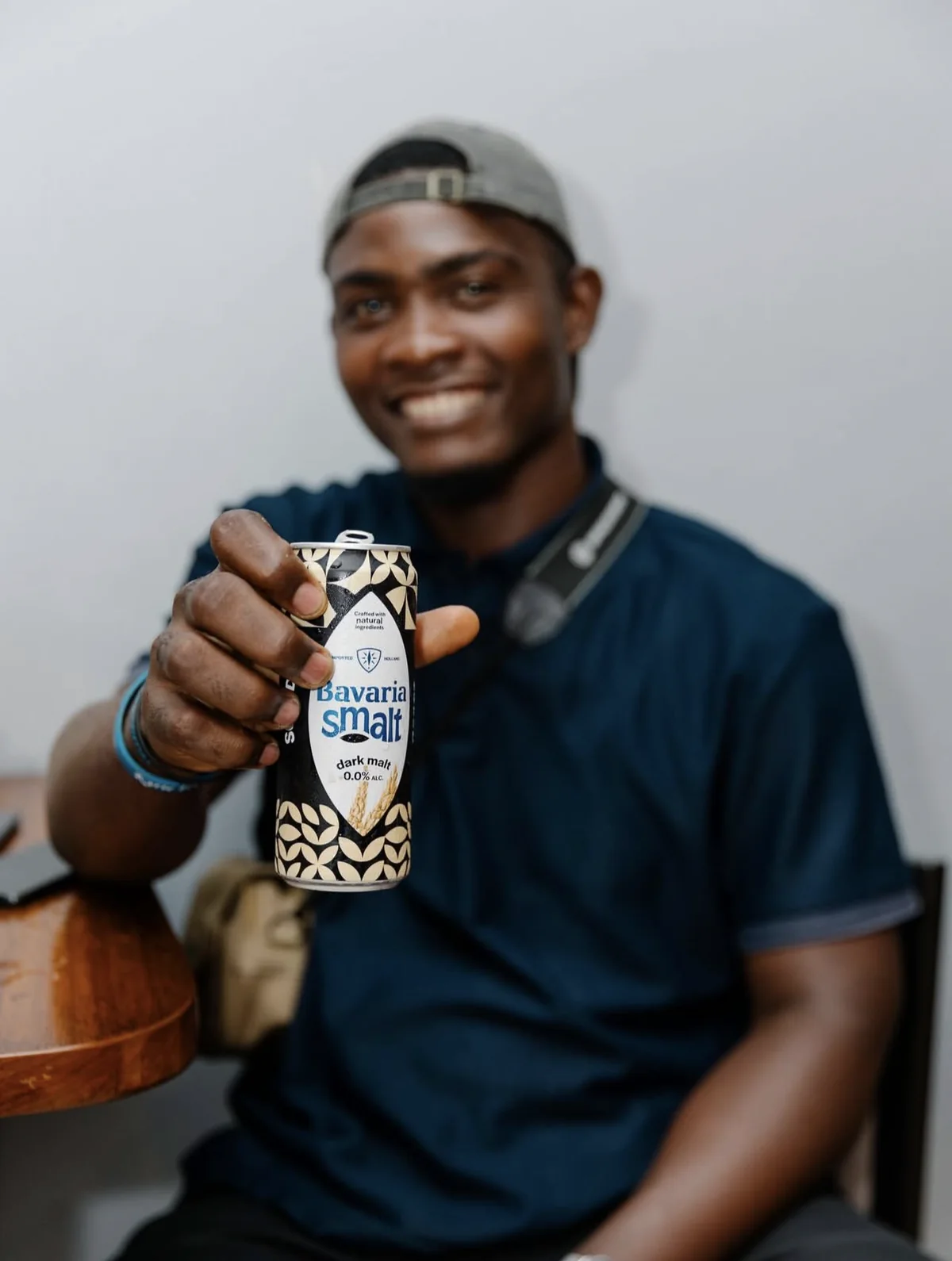 Portrait souriant d'un invité tenant une Bavaria Smalt
